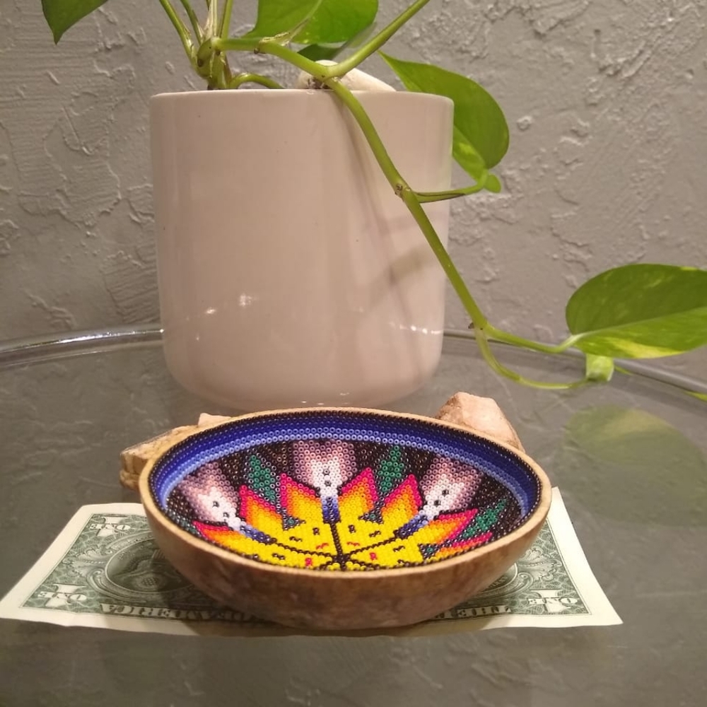 This is a wooden bowl with beads